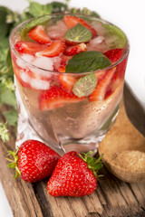 mojito strawberry cocktails, strawberry, mint leaves on a wooden