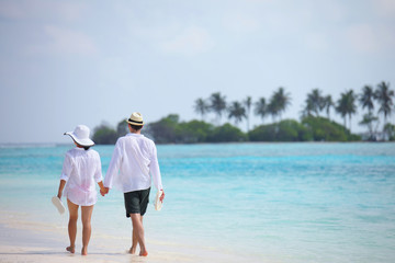 happy young couple have fun on beach