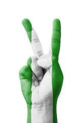 Hand making the V sign, Nigeria flag painted