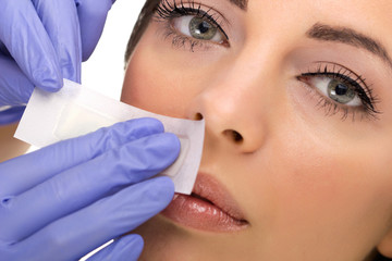 woman reciving facial epilation