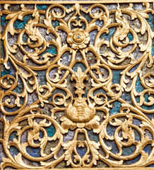 Ancient golden carving wooden window of Thai temple. Thailand