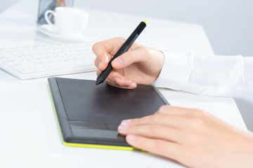 Designer hand drawing a graph on the tablet