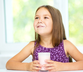 Cute little girl showing milk moustache
