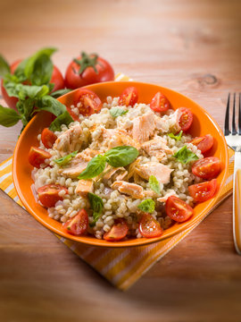 barley risotto with fresh salmon and tomatoes, selective focus