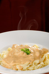chicken breast with vegetables in a creamy sauce with pasta