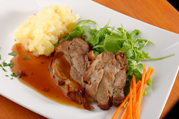 Fried pork chop, mashed potato and vegetable salad