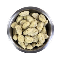 A bowl of potato gnocchi on a white background