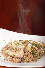 Buckwheat porridge with mushrooms and onions on the dining table