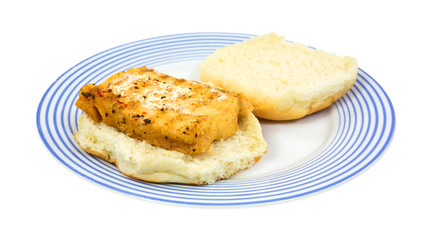 A single portion of haddock on an open bun