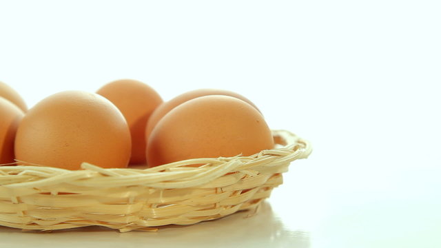 Brown fresh eggs on white background