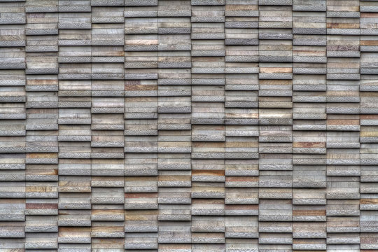 Modern mosaic wall constructed with stone plates