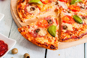Pizza with salami, tomatoes and olives