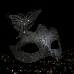 Carnival mask  and champagne on black background