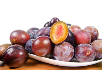 fresh plums on wooden table