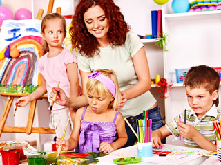 Child painting at easel.