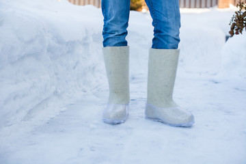 Close-up of warm boots for men's feet on the white snow
