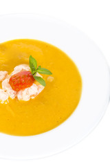 Pumpkin soup with shrimp and tomato