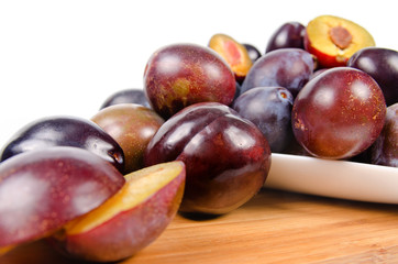 fresh plums on wooden table