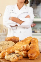 Woman cook and table with lot of homemade baked goods
