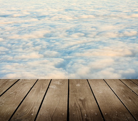 Fototapeta na wymiar empty wooden deck table with clouds.