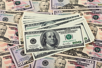 Fototapeta premium Stack of one hundred dollar bills on money background