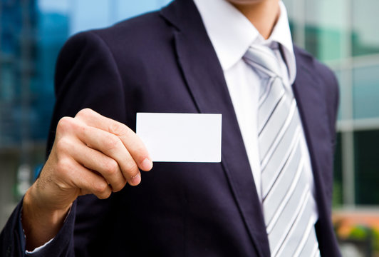 Young Businessman Holding Visit Card In Hand  