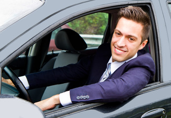 Happy man in his new car