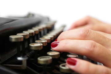 close up of woman typing with old typewriter