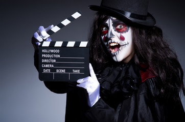 Monster with movie clapper board