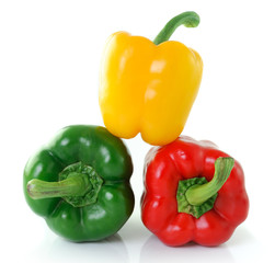 green yellow red pepper on white background