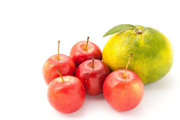 small apples and a big orange