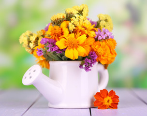 Bouquet of marigold flowers in watering can