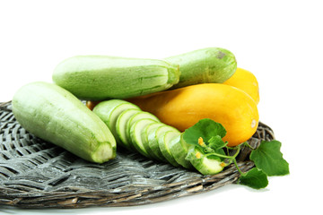 Sliced and whole raw zucchini, isolated on white