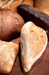 Much bread on wooden board