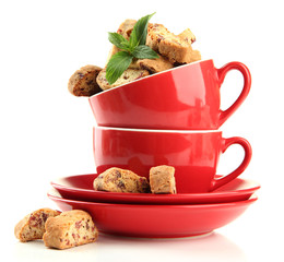 Tasty cookies in cups isolated on white