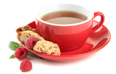 Cup of tea with cookies and raspberries isolated on white