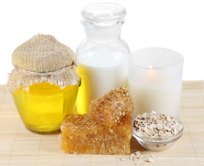 Honey and milk spa with oils and honey isolated on white