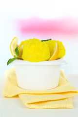 Tasty ice cream scoops in bowl, on wooden table