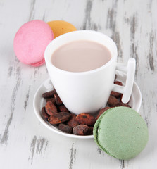 Cocoa drink, macaroni and cocoa beans on wooden background