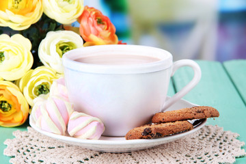 Cocoa drink on wooden  table, on bright background