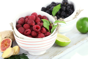 Raspberries and blackberry in small bowls