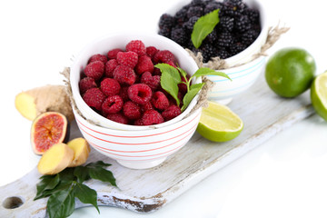 Raspberries and blackberry in small bowls
