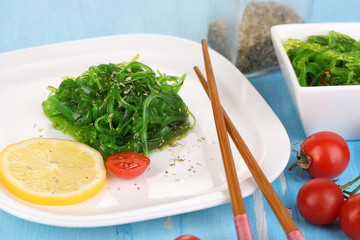 Sea kale on plate on wooden table close-up