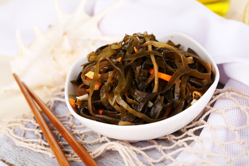 Sea kale in bowl on wooden table close-up
