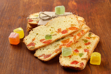 Biscotti with candied fruits, on wooden background