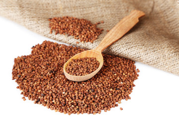 Buckwheat groats and wooden spoon closeup
