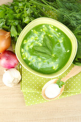 Tasty spinach soup, on wooden table