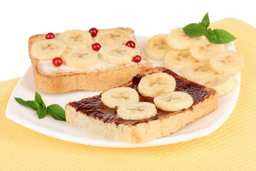 Delicious toast with bananas on plate close-up
