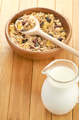 Plate with raw oatmeal on wooden table.