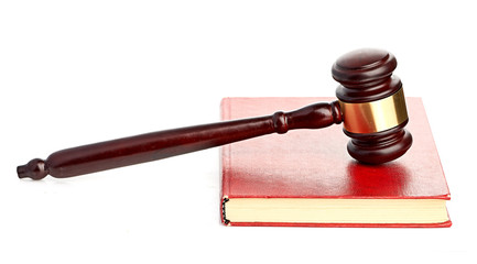 Judge's gavel on red legal book